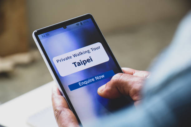 istock Man using mobile applications to enquire private walking tour for his upcoming trips to Taipei. Vacation planning using concepts, digital display. 2203339267