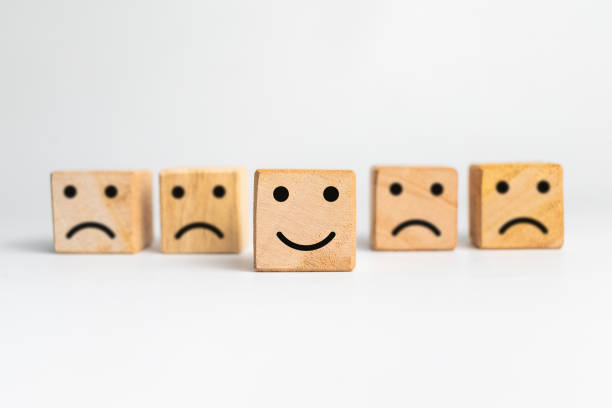 istock sad faces and happy face expression emoji on wooden block isolated on white background 2203342294