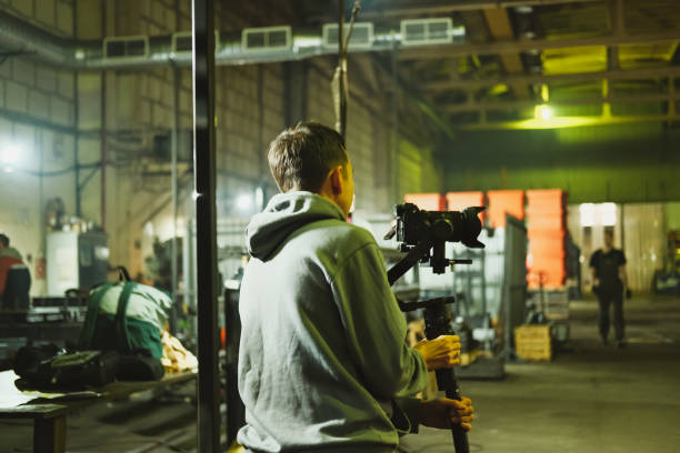 istock Filmmaker preparing to shoot in a spacious industrial setting 2203342342