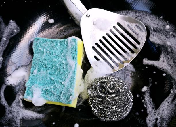 istock Using Sponge to clean kitchen utensils - food preparation. 2203343880