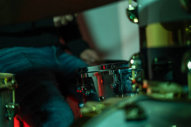 Capturing the energy and excitement behind the scenes at an instrumental music concert with drums and guitar, the dynamic world behind the scenes before and during the musical show with the group