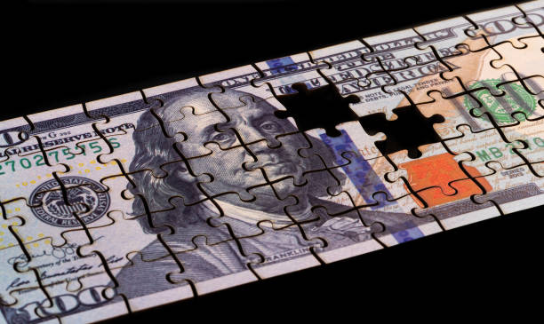 istock Puzzle-assembled $100 banknote with a portrait of Benjamin Franklin 2203347082