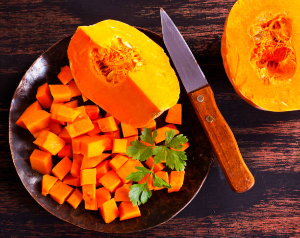 istock raw pumpkin, fresh pumpkin on plate 2203349006