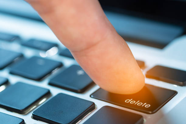 istock Finger of the computer user, he presses the delete button on the computer keyboard. 2203351557
