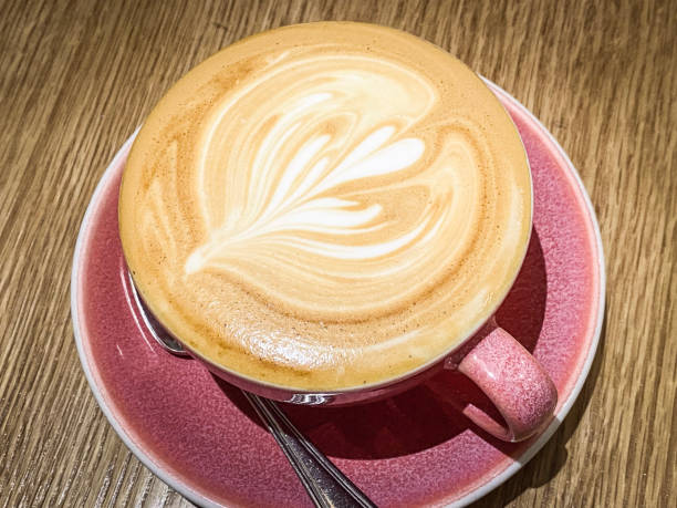 istock Latte Art in a Pink Cup on Wooden Table 2203354050