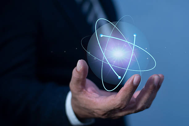 istock Businessman hand holding creative atom. Nuclear fusion concept, endless energy, cheap electricity, Innovative technologies, Future technologies. Science and future concept 2203354761