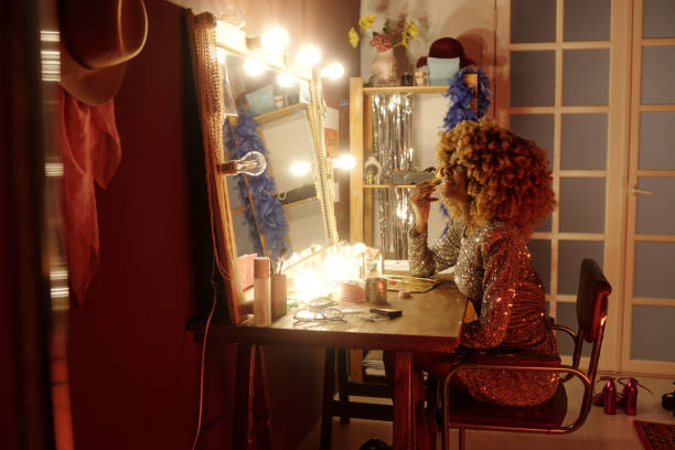 istock Applying Makeup in Front of Illuminated Mirror 2203358336