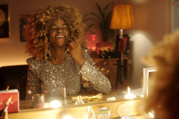istock Laughing Woman Applying Makeup in Stylish Room 2203358359