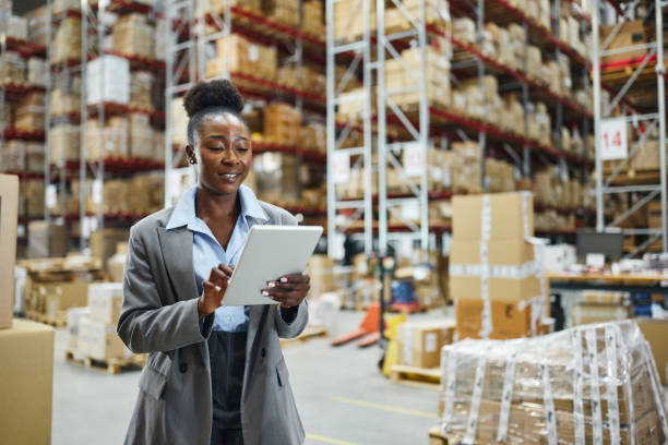 istock Happy black female inspector working on touchpad in supply chain. 2203360989