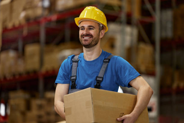 istock Happy warehouse worker with a package in storage room. 2203361268