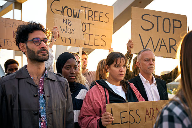 istock Diverse people silently protesting with serious expression against war and violence in world 2203361388