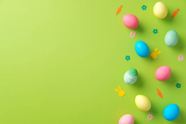 istock Abstract Easter background with colorful eggs and confetti on vibrant green table. Easter banner design, greeting card template. Minimal style. 2203363435