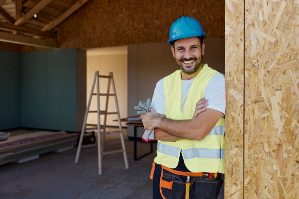 istock Happy construction worker with crossed arms during home renovation. 2203364499