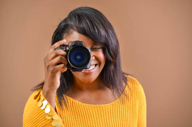 istock Young photographer smiling while taking photos 2203365099