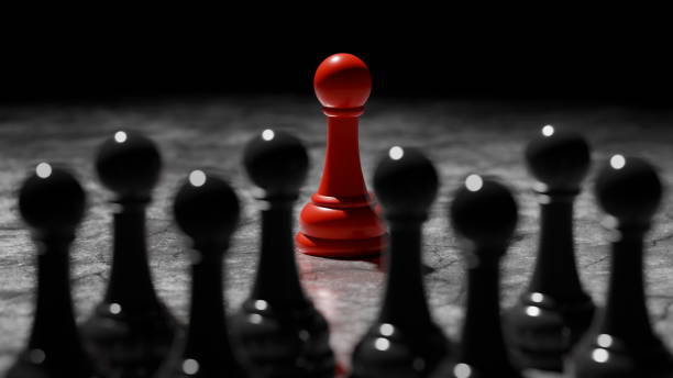 single red pawn prominently displays its color while surrounded by black chess pieces on a dark surface, creating a striking contrast during an evening game focused on strategy. 3d render