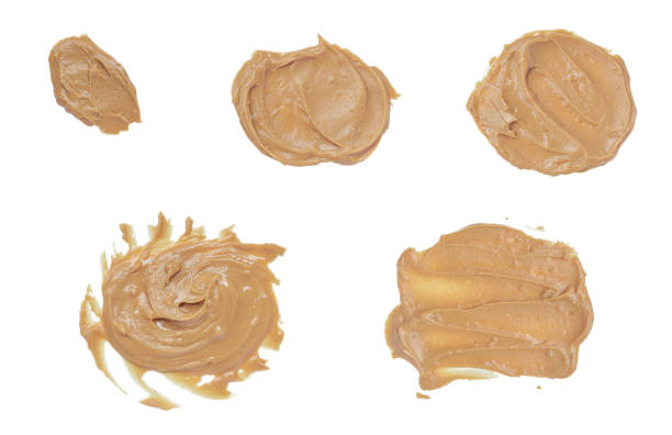 istock Collage of Tasty peanut creamy paste smears isolated on white background with clipping path. nut butter from above view 2203365889