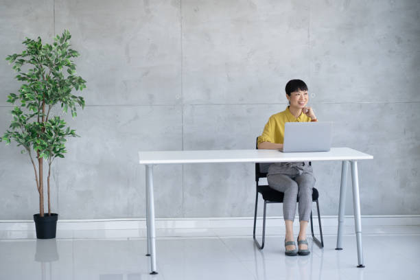 istock Professional woman confidently using a laptop in an office 2203366563