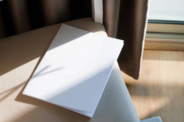 istock blank magazine mockup on soft armchair , shadow overlay 2203366812