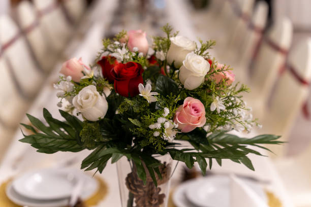 istock Bouquet of red, white, and pink roses on wedding table 2203367855