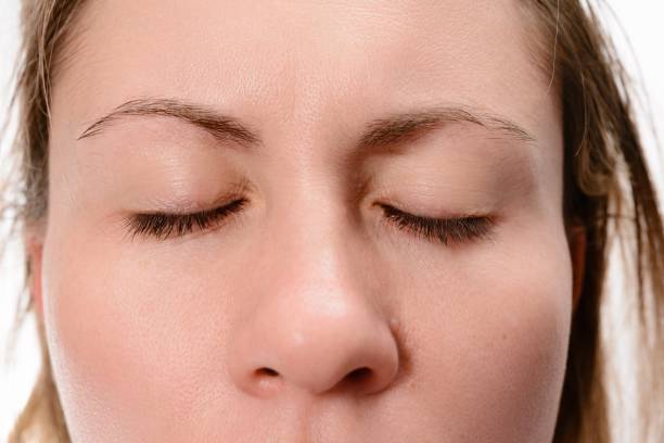istock Close-up of a woman's face with closed eyes. 2203368438