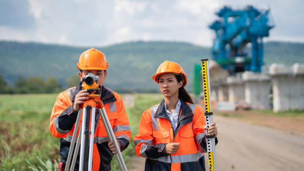 istock The survey team is using a theodolite and road construction plans. Civil engineers are measuring with surveying tools during the construction. 2203368564