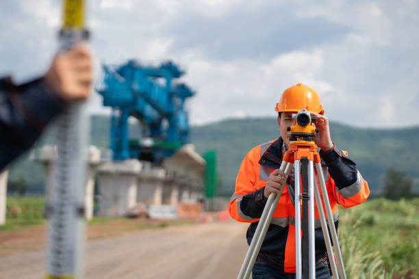 istock The survey team is using a theodolite and road construction plans. Civil engineers are measuring with surveying tools during the construction. 2203368689