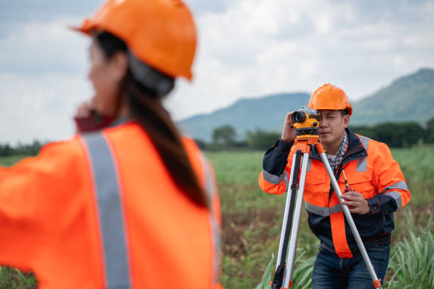 istock The survey team is using a theodolite and road construction plans. Civil engineers are measuring with surveying tools during the construction. 2203368741