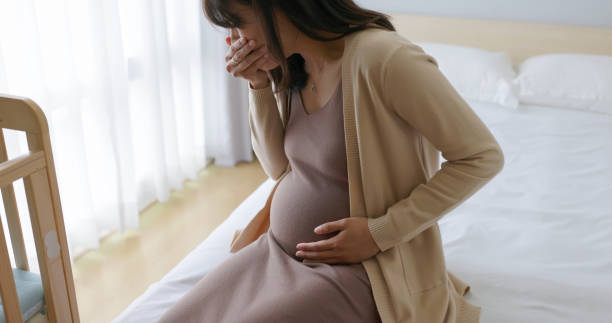 istock asian pregnant woman nausea vomit 2203369263