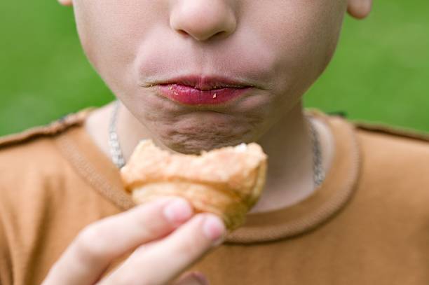 A girl pictured in front of the typical steep stairs of Bonifacio houses, eating ice cream.