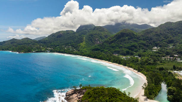 istock Tropical bay with turquoise water and mountainous backdrop. Seychelles, Mahe. 2203369934