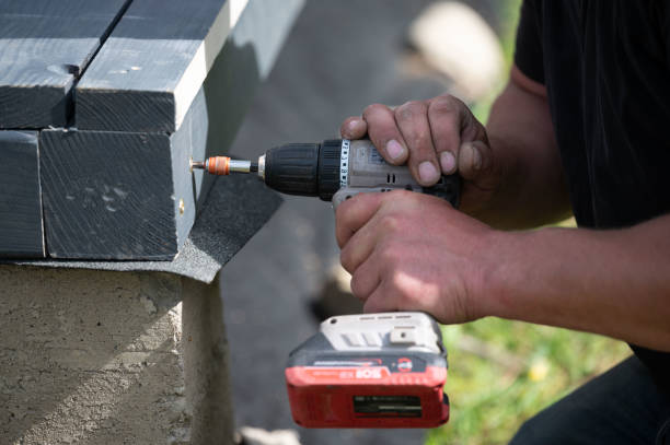 istock A man is drilling screws into wooden beams 2203370163