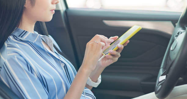 istock businesswoman use mobile phone car 2203370314