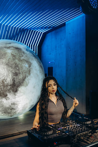 istock DJ Performing in Futuristic Environment With Moon and LED Lighting 2203370748