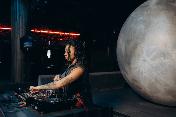 istock DJ Playing Music in a Modern Club with a Spherical Decoration 2203371103