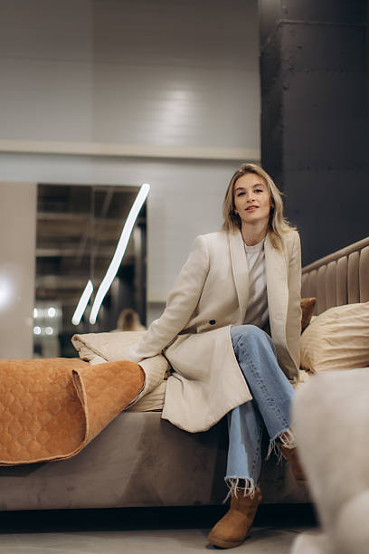 istock Young Woman Relaxing in a Modern Interior Sitting on a Comfortable Bed 2203372337