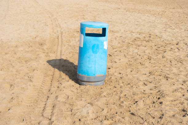 Trash can on the beach, recycling, sand, sunny day.