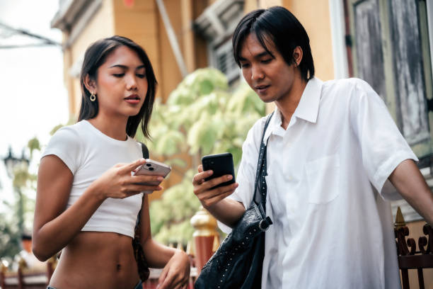 LGBTQ friends talking and laughing together on street, Bangkok Thailand