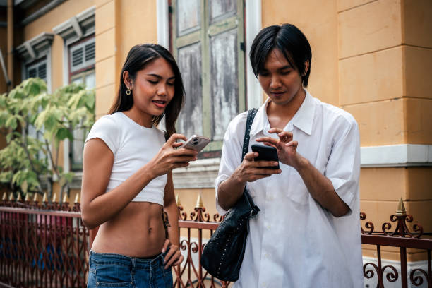 Happy LGBTQ friends talking and laughing together on street, Bangkok Thailand