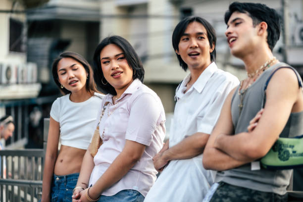 Happy LGBTQ friends talking and laughing together on street, Bangkok Thailand