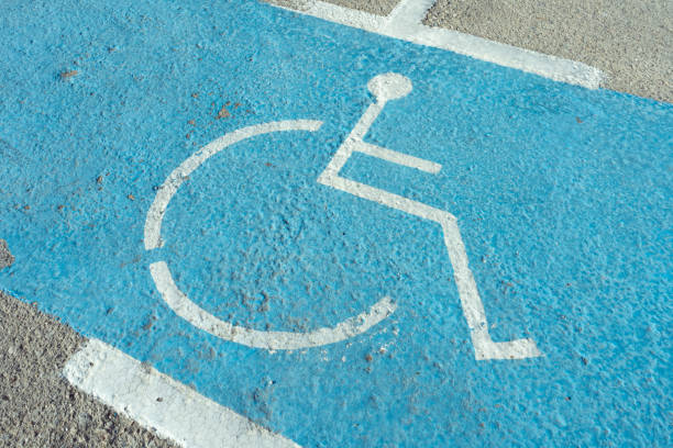 istock Disabled parking space with wheelchair icon painted on street surface 2203373949