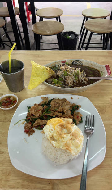 istock Basil pork rice with a fried egg, served with a side dish of Thai-style spicy pork soup 2203374158