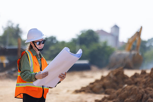 istock A female engineer  reviews blueprints at a construction site. 2203374481