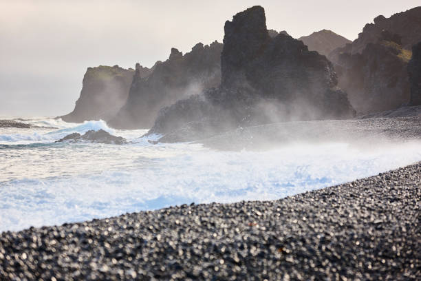 Volcanic rocks and black pebbles beach. Dritvik. Snaefellnes Peninsula. Iceland