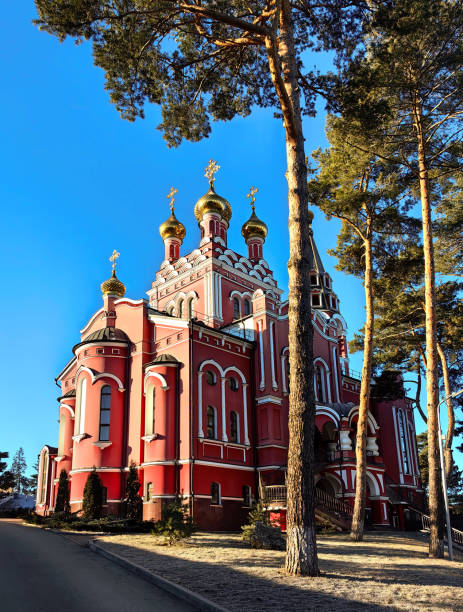 Russian Orthodox Church surrounded by yellow trees.