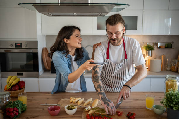 istock Young couple filming cooking show in kitchen 2203379894