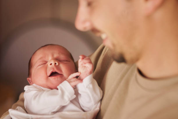 istock Father, smile and hug sleeping baby in home, growth development and bond to connect with infant. Closeup, love and dad for protection in childhood, newborn nap and child care with dream in embrace 2203380064