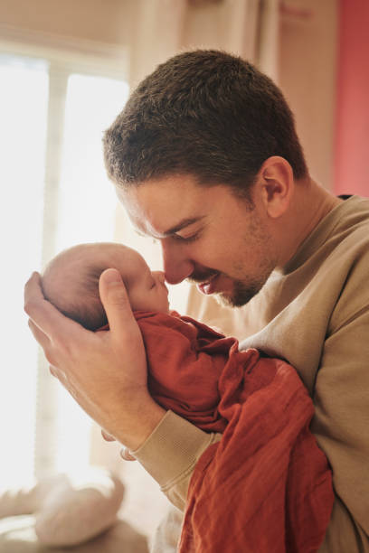 istock Father, nose touch and sleeping baby in home, growth development and bond to connect with infant. Nursery, love and dad for protection in childhood, newborn nap and child care with dream in embrace 2203380145