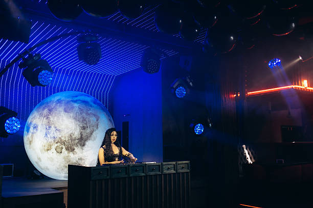 istock DJ Performing in Modern Club with Dramatic Lighting and Moon Decoration 2203380452