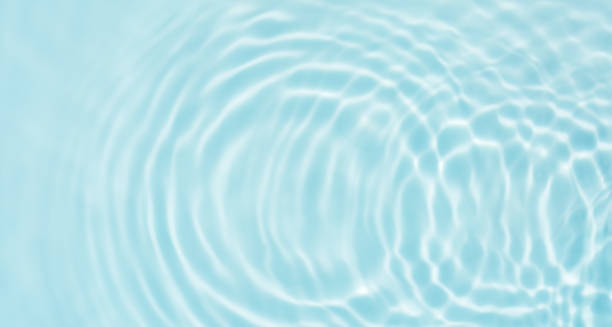 istock Water ripple surface, Summer backgrounds, Water waves abstract pattern texture on swimming pool,Top view poolside with light shadow on blue water 2203382146