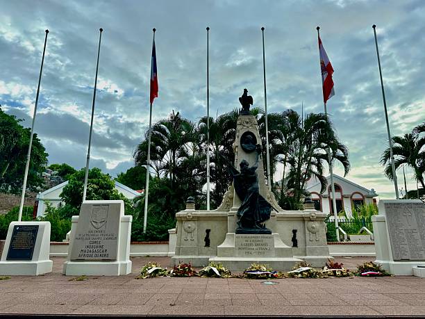 istock War memorial with flags at half-mast stands in a public square. 2203382344